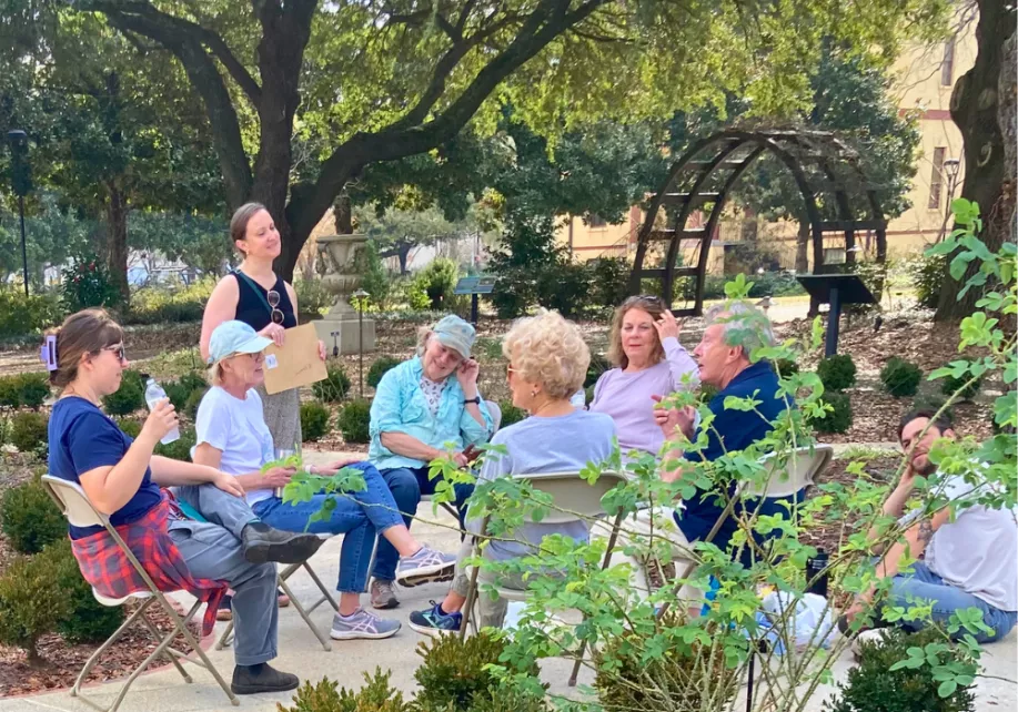 Volunteers relaxing in a circle of chairs in the garden